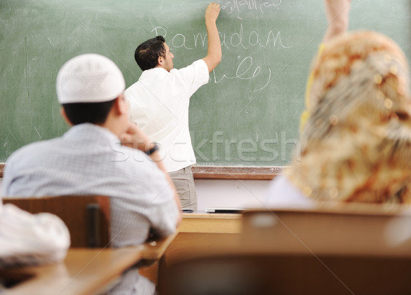 Stock photo: Muslim arabic teacher writing on board