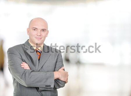 Young, balded head businessman with folded hands in bright workplace  Stock photo © zurijeta