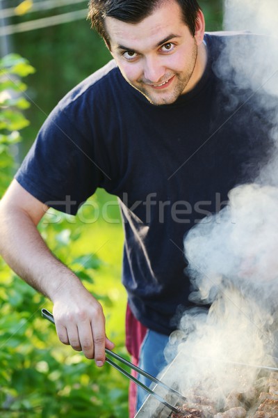 Lángok grillezés steak BBQ tűz arc Stock fotó © zurijeta