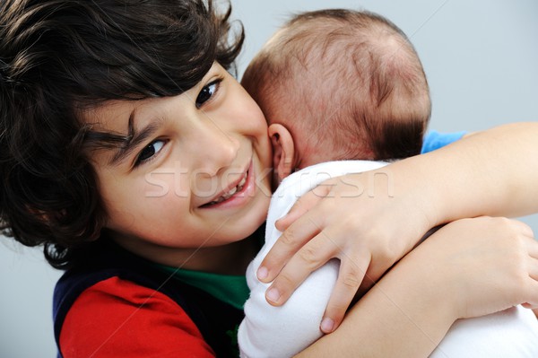 Little boy playing with his new baby brother Stock photo © zurijeta