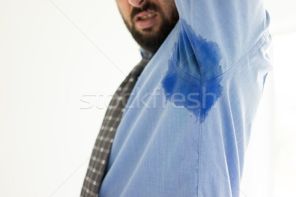Business man with sweating under armpit in blue shirt Stock photo © zurijeta