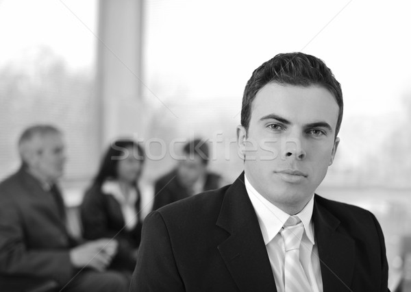Serious businessman in company with colleagues Stock photo © zurijeta