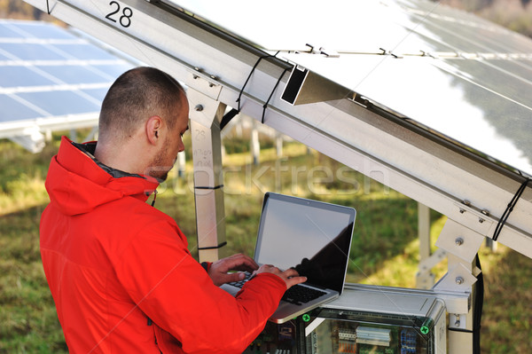 Engineer working with laptop by solar panels  Stock photo © zurijeta