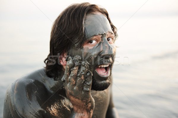 Man in a bathing suit of natural mineral mud sourced from the dead sea in Jordan Stock photo © zurijeta