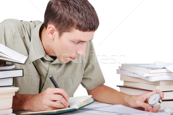 Young man writting on desk with books Stock photo © zurijeta