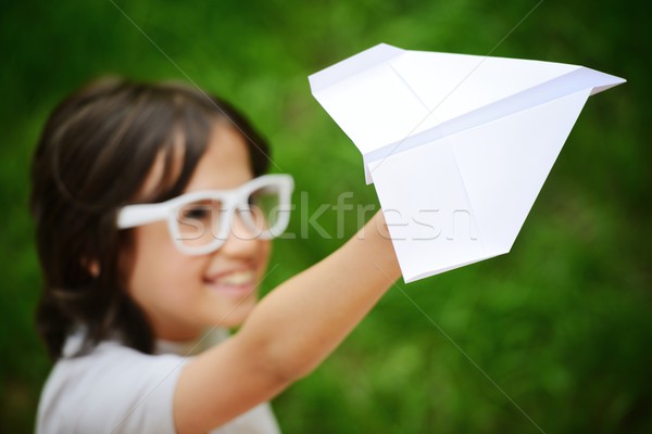 Kid flying a paper airplane Stock photo © zurijeta