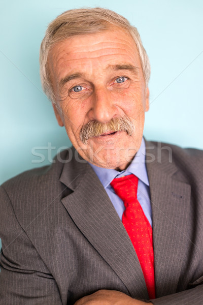 Stock photo: Portrait of a smiling and confident mature businessman with must