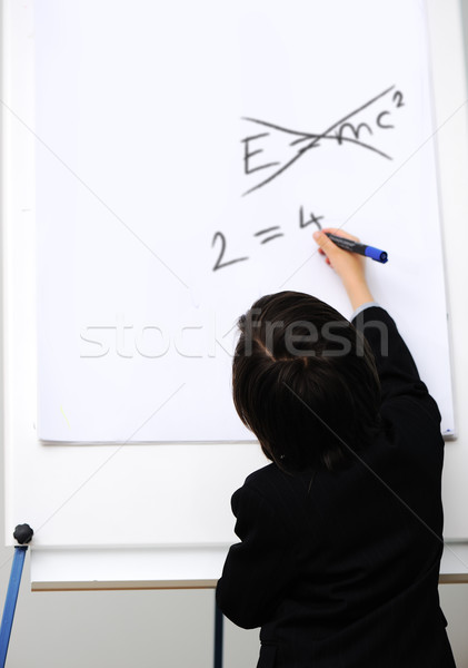 Genius little boy writting E=mc2 on the board, new formula instead, conceptual idea Stock photo © zurijeta