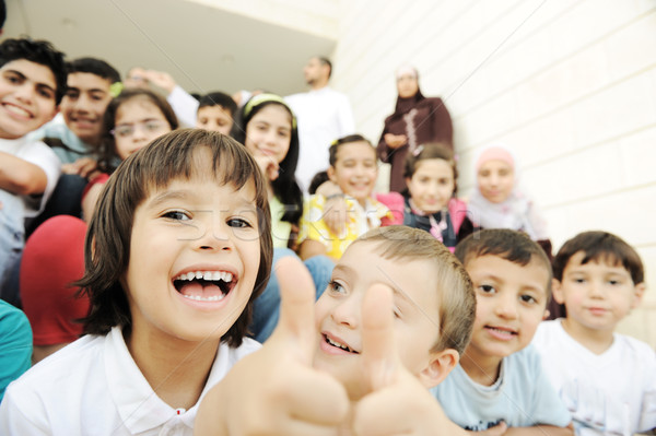 Stock photo: Crowd of children, different ages and races in front of the school, breaktime