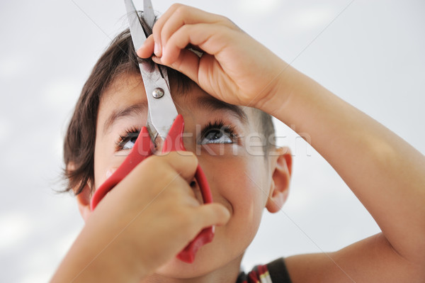 Kid cutting hair to himself with scissors, funny look Stock photo © zurijeta