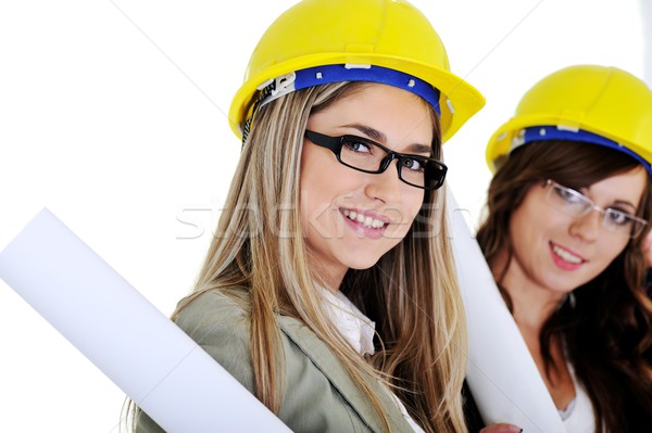 Young architects wearing a protective helmet and holding bluepri Stock photo © zurijeta