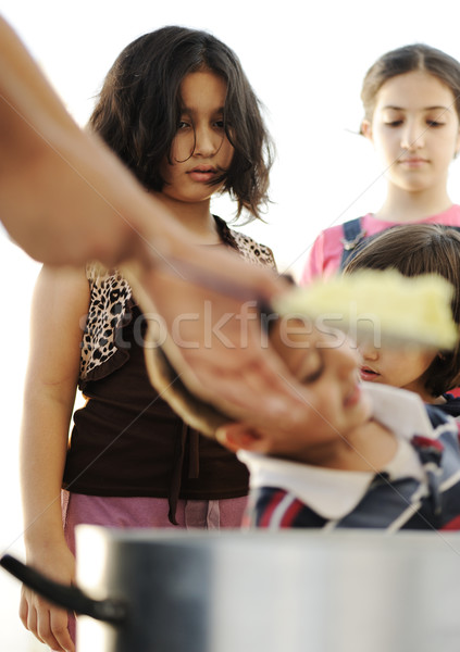 Hungry children in refugee camp, distribution of humanitarian food Stock photo © zurijeta