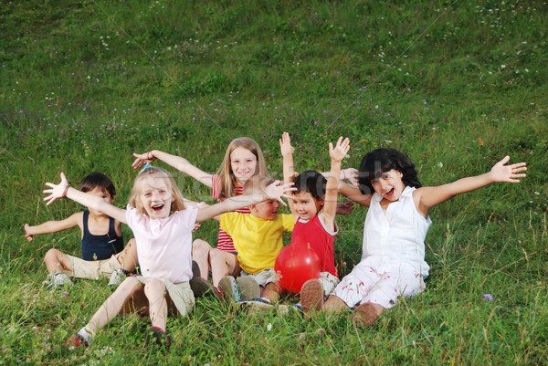  happy children raising hands upwards Stock photo © zurijeta