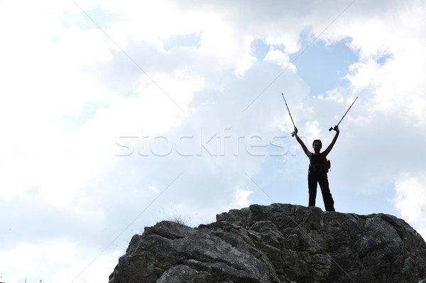 Silhouette of a woman during and adventage climbing and mountain walking Stock photo © zurijeta