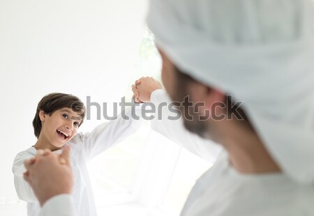 Stock photo: Happy Arabic family having fun time, playful father and son