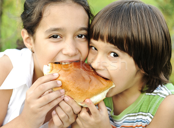 Boy and girl eating together in nature Stock photo © zurijeta