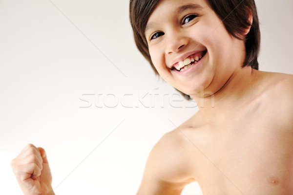Child showing the muscles of his arms Stock photo © zurijeta