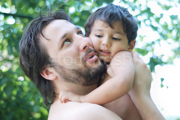 Lovely boy and his father holding him in hands in nature Stock photo © zurijeta