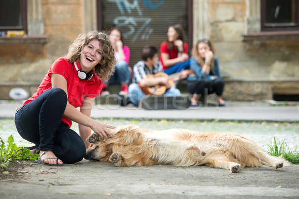 Smiling girl petting a dog Stock photo © zurijeta