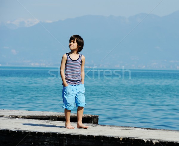 Kicsi fiú sétál dokk gyönyörű tenger Stock fotó © zurijeta