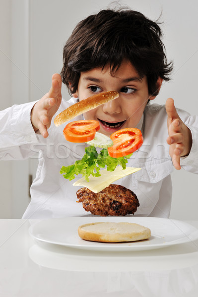 Little boy with hamburger ingredients in hands Stock photo © zurijeta