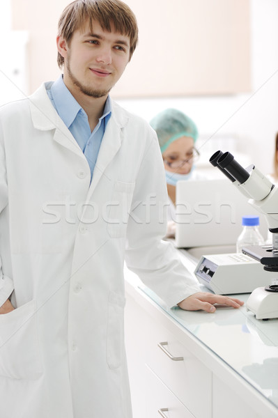 Stock photo: Successful team working with microscopes in a laboratory