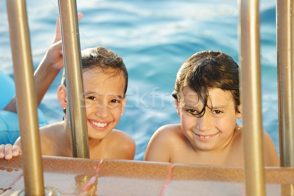 Children fun playing with water on summer pool Stock photo © zurijeta