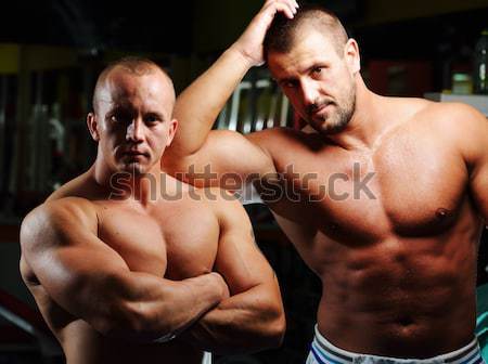 Athletic bodybuilder, execute exercise in sport gym hall Stock photo © zurijeta