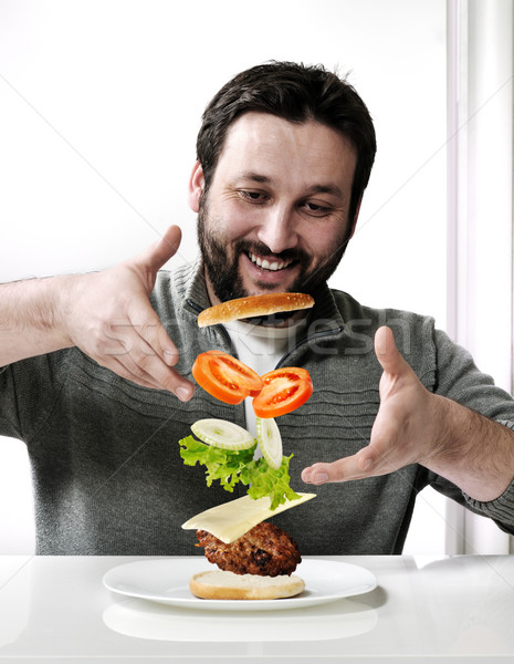 Adult man making a burger Stock photo © zurijeta