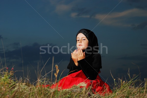 Little muslim girl on meadow, before sunset Stock photo © zurijeta