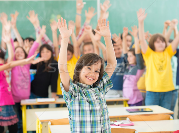 Happy children group with arms outstretched in school classroom Stock photo © zurijeta