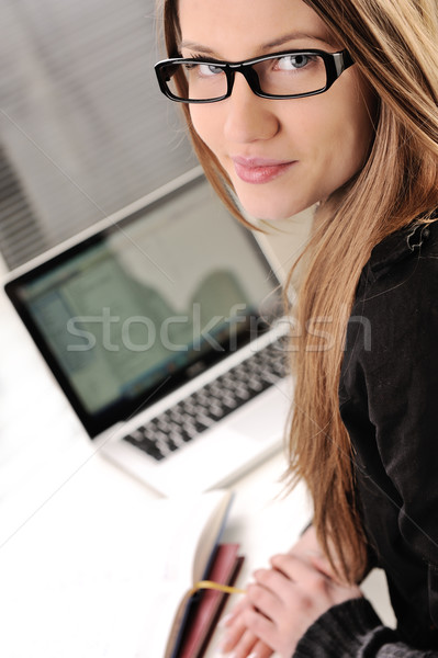 Stock photo: Beautiful female teenager with laptop and books