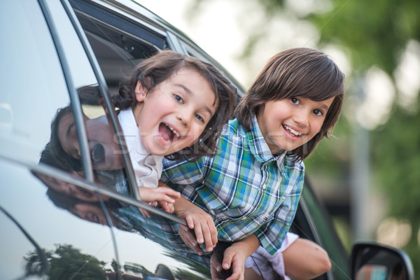 Two kids looking out from car window Stock photo © zurijeta