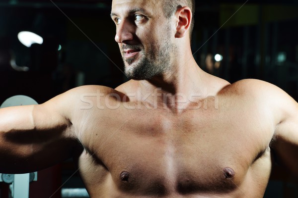 Athletic bodybuilder, execute exercise in sport gym hall Stock photo © zurijeta