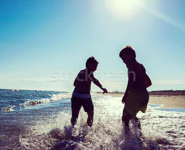 Fun kids playing splash at beach Stock photo © zurijeta