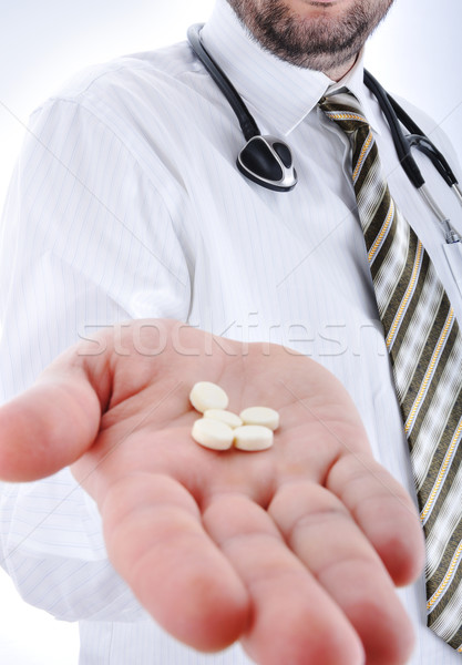 Stock photo: Young doctor offering pill