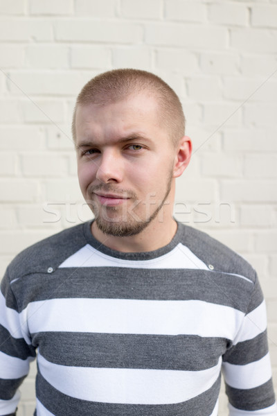 Young man in wearing shirt on white brick wall background Stock photo © zurijeta