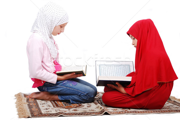 A young muslim girls in traditional clothes reading Koran Stock photo © zurijeta