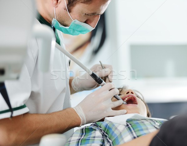 Young dentist at work in the office Stock photo © zurijeta