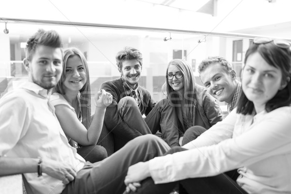 Group of young people sitting on floor indoors Stock photo © zurijeta