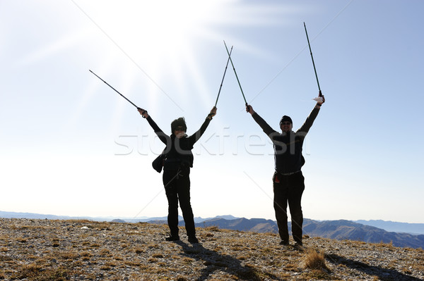 Rock-climbers on background mountain landscape with the hands stretched in sides Stock photo © zurijeta