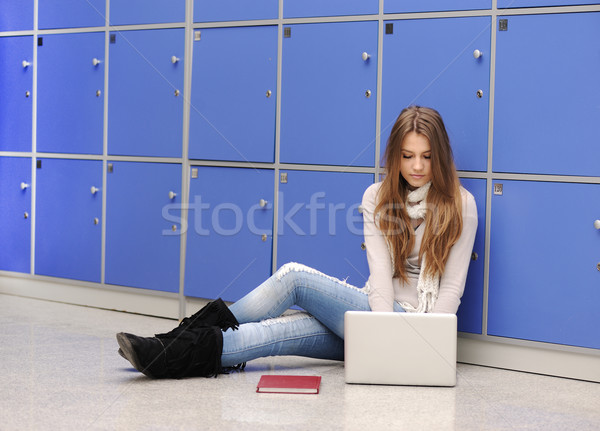 Beautiful female student sitting on ground with laptop Stock photo © zurijeta