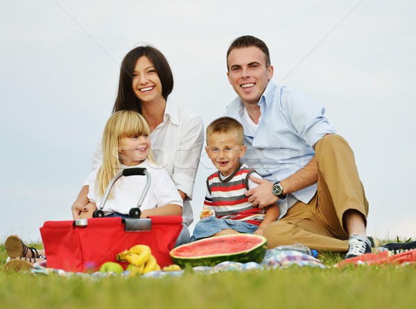 Family with children having picnic time on green meadow in natur Stock photo © zurijeta