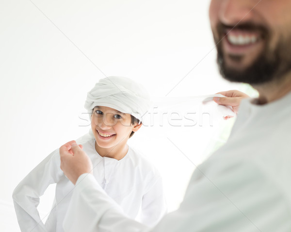 Happy Arabic father making headscarf to his son Stock photo © zurijeta