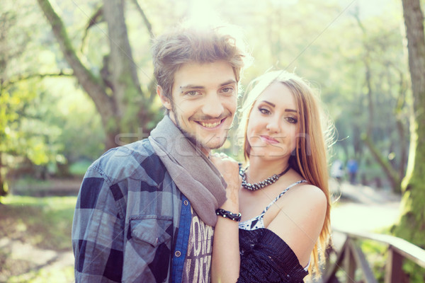 Young couple having good time together in park on river Stock photo © zurijeta