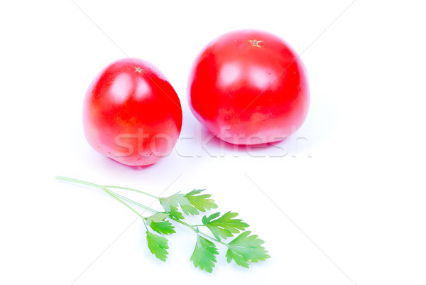 Two pieces of tomato and green lief of parsley Stock photo © zurijeta
