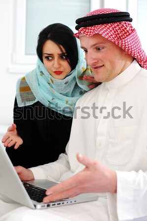 Stock photo: Arabic parents and little boy at home with laptop computer