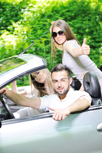 Three friends in a sports car with thumbs up Stock photo © zurijeta