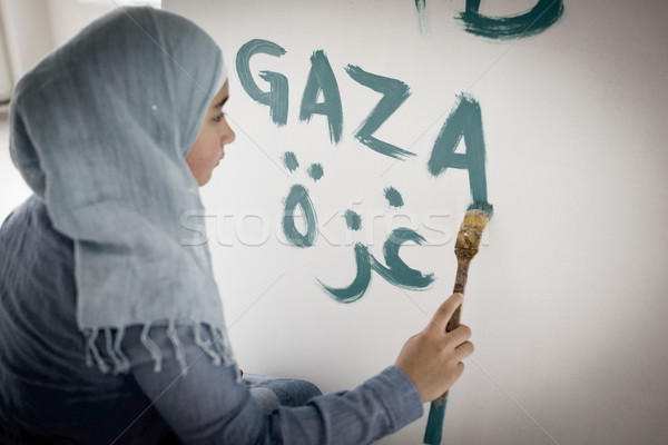 Arabic Muslim girl writing messages on board Stock photo © zurijeta