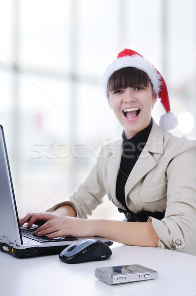 Pretty female wearing santa hat, holding organiser, using mobile, smiling in office Stock photo © zurijeta